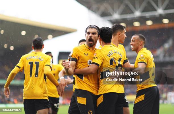 Hwang Hee-chan celebrates with Ruben Neves of Wolverhampton Wanderers after scoring their team's second goal during the Premier League match between...