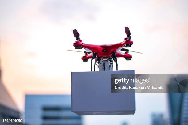 autonomous delivery drone controlled via smartphone - drone parcel stock pictures, royalty-free photos & images