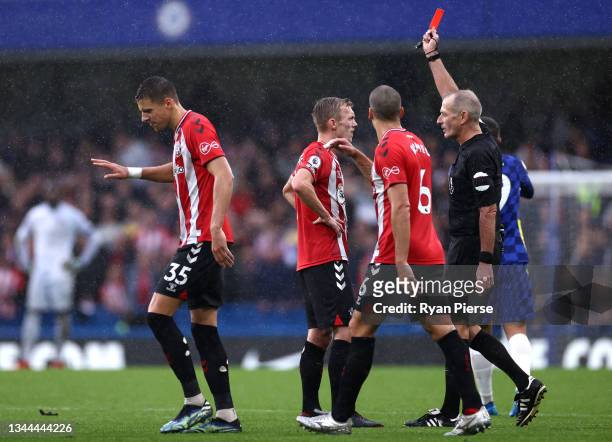 Match referee, Martin Atkinson shows a red card to James Ward-Prowse of Southampton during the Premier League match between Chelsea and Southampton...