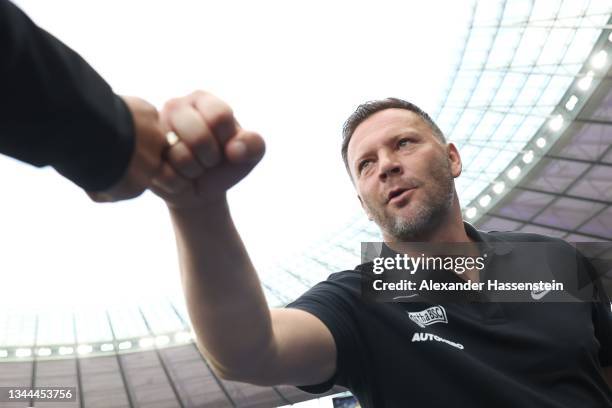Pal Dardai, head coach of Berlin bumps fists during the Bundesliga match between Hertha BSC and Sport-Club Freiburg at Olympiastadion on October 02,...
