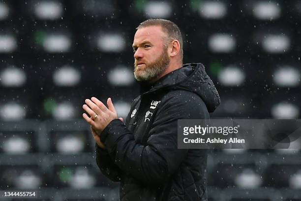 Wayne Rooney, head coach of Derby County applauds the home supporters during the Sky Bet Championship match between Derby County and Swansea City at...