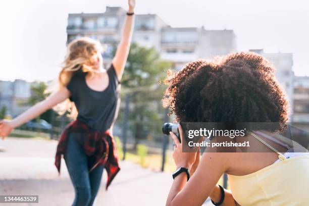 two teenage girls having fun outside - child film director stock pictures, royalty-free photos & images