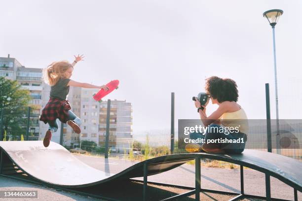 two teenage girls having fun outside - director camera stock pictures, royalty-free photos & images