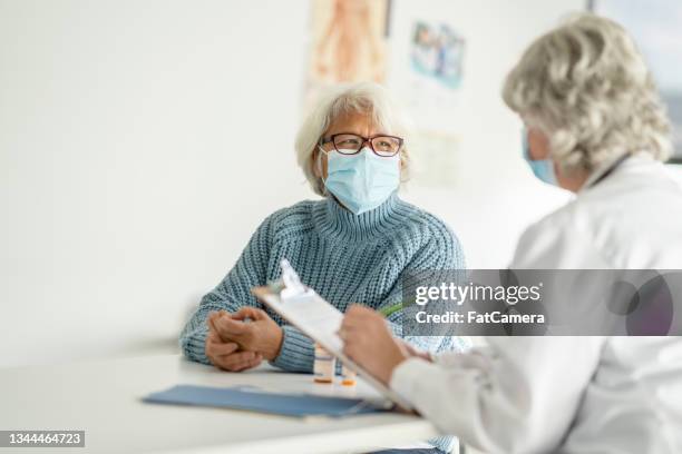 filling out a health history form during covid - patient history stock pictures, royalty-free photos & images