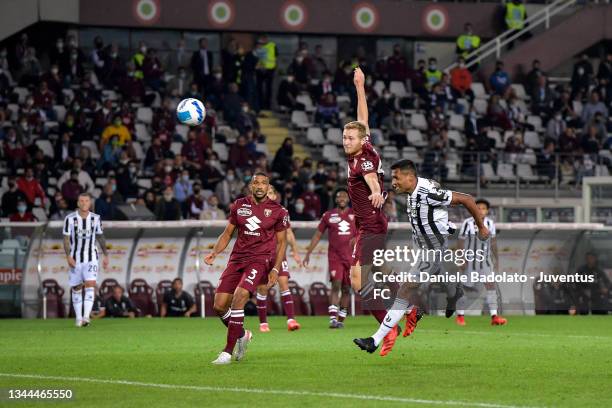 Alex Sandro of Juventus in action against Tommaso Pobega of Torino FC during the Serie A match between Torino FC v Juventus at Stadio Olimpico di...