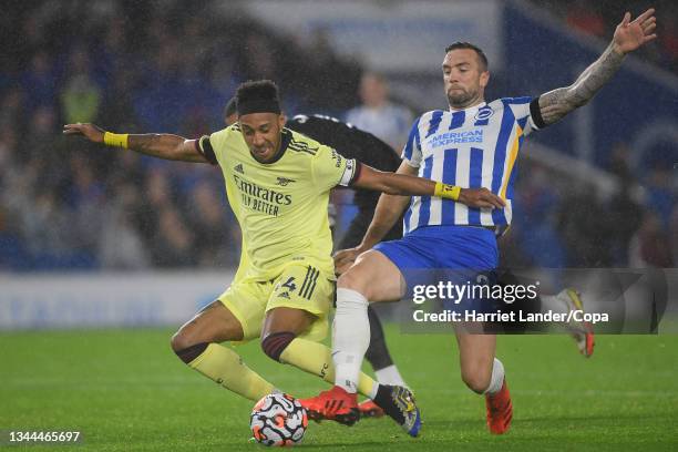 Pierre-Emerick Aubameyang of Arsenal is challenged by Shane Duffy of Brighton inside the penalty area and Hove Albion during the Premier League match...