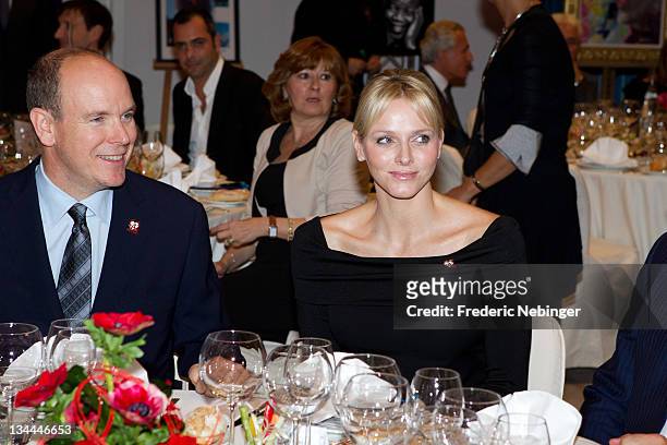 Prince Albert II of Monaco and Princess Charlene of Monaco attend the Fight Aids Monaco Gala And Auction 2011 on December 1, 2011 in Monaco.