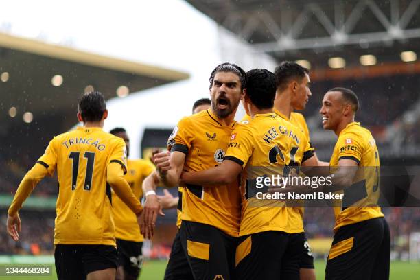 Hwang Hee-chan celebrates with Ruben Neves of Wolverhampton Wanderers after scoring their team's second goal during the Premier League match between...