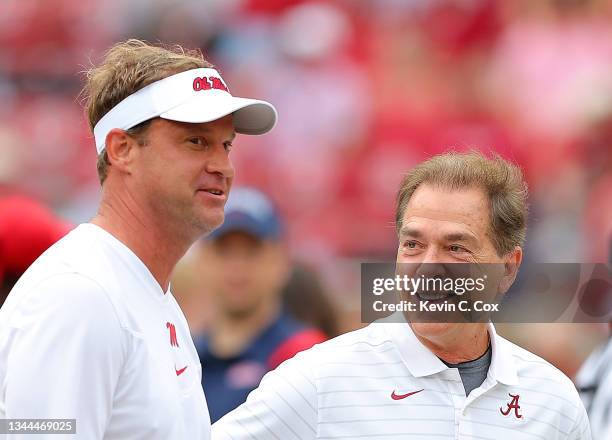 Head coach Nick Saban of the Alabama Crimson Tide converses with head coach Lane Kiffin of the Mississippi Rebels prior to facing each other at...