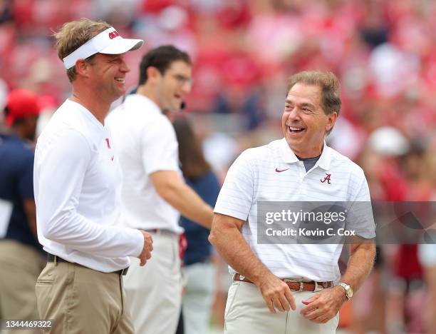 Head coach Nick Saban of the Alabama Crimson Tide converses with head coach Lane Kiffin of the Mississippi Rebels prior to facing each other at...