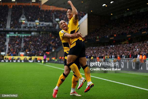 Hwang Hee-chan celebrates with Marcal of Wolverhampton Wanderers after scoring their team's second goal during the Premier League match between...