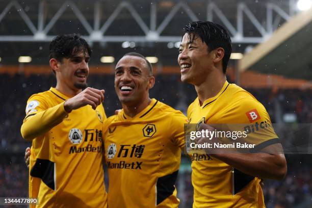 Hwang Hee-chan celebrates with Francisco Trincao and Marcal of Wolverhampton Wanderers after scoring their team's second goal during the Premier...