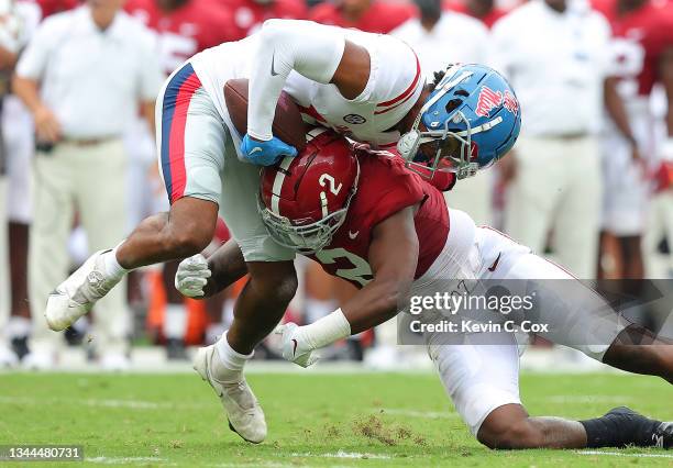 Jadon Jackson of the Mississippi Rebels pulls in this reception as he is tackled by DeMarcco Hellams of the Alabama Crimson Tide during the first...