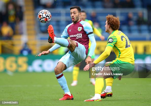 Dwight McNeil of Burnley controls the ball ahead of Josh Sargent of Norwich City during the Premier League match between Burnley and Norwich City at...