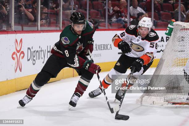 Nick Schmaltz of the Arizona Coyotes skates with puck pressured by Brogan Rafferty of the Anaheim Ducks during the first period of the NHL game at...