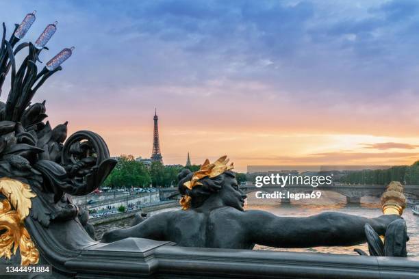 sunset on alexandre iii bridge and tour eiffel in background - river seine stock pictures, royalty-free photos & images