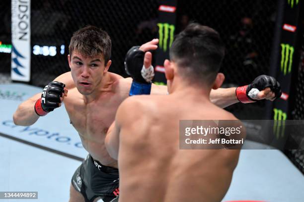 Alexander Hernandez punches Mike Breeden in their lightweight bout during the UFC Fight Night event at UFC APEX on October 02, 2021 in Las Vegas,...