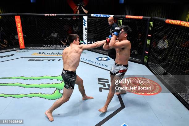 Alexander Hernandez punches Mike Breeden in their lightweight bout during the UFC Fight Night event at UFC APEX on October 02, 2021 in Las Vegas,...