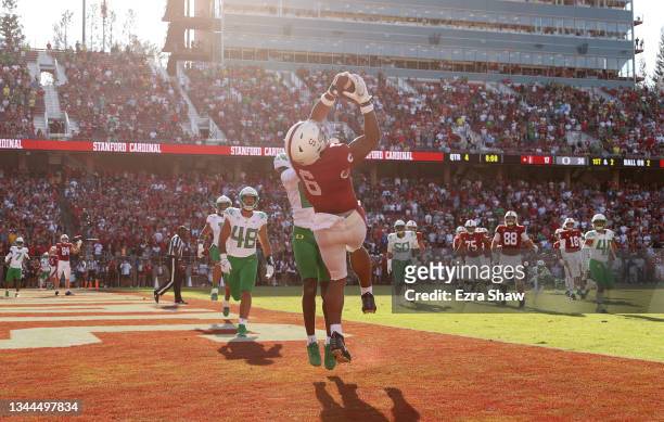 Elijah Higgins of the Stanford Cardinal makes the tying touchdown catch at the end of the fourth quarter while covered by DJ James of the Oregon...