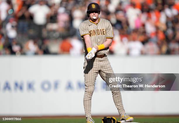 Jake Cronenworth of the San Diego Padres stands on second base after hitting an RBI double which scored Victor Caratini against the San Francisco...