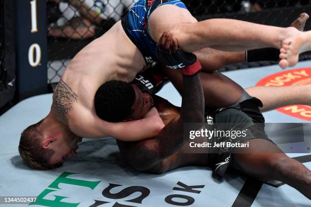 Kyle Daukaus attempts to submit Kevin Holland in their middleweight bout during the UFC Fight Night event at UFC APEX on October 02, 2021 in Las...