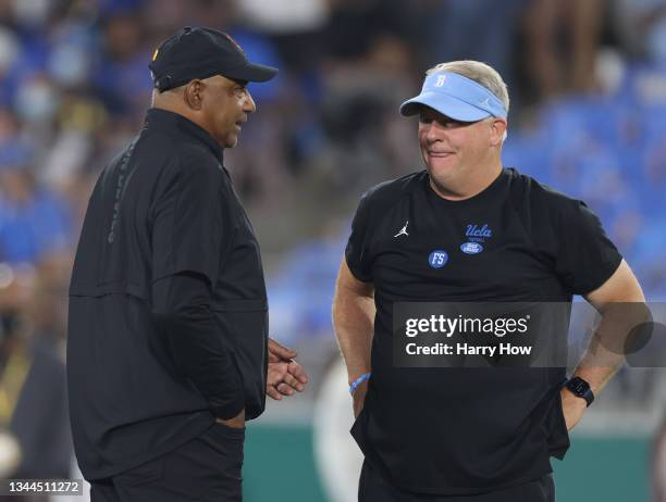 Head coach Chip Kelly of the UCLA Bruins and head coach Marvin Lewis of the Arizona State Sun Devils talk before the game at Rose Bowl on October 02,...