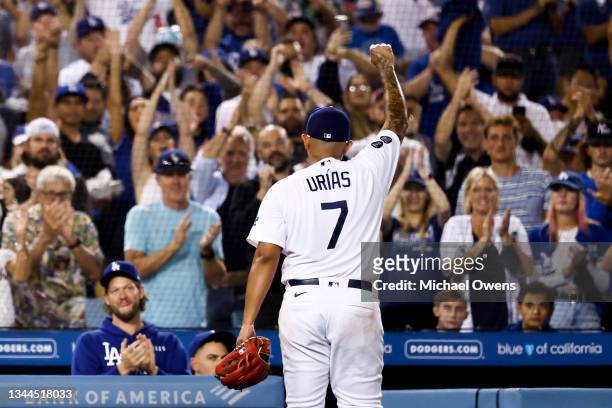 Julio Urias of the Los Angeles Dodgers reacts to the crowd as he exits the game in the seventh inning against the Milwaukee Brewers at Dodger Stadium...