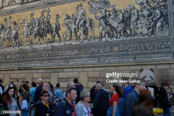 Visitors throng the city center under the Procession of Princes porcelain tiles mural during the annual Canaletto city fest on October 02, 2021 in...