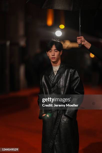 Mark Tuan wearing a black leather coat and a white balenciaga shirt outside Balenciaga on October 02, 2021 in Paris, France.