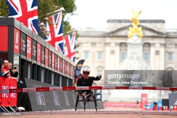 Marcel Hug of Switzerland celebrates winning the Men's Elite Wheelchair race during the 2021 Virgin Money London Marathon on October 03, 2021 in...