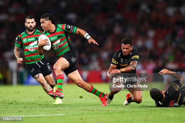 Cody Walker of the Rabbitohs beats the tackle of Apisai Koroisau and Nathan Cleary of the Panthers on his way to score a try during the 2021 NRL...