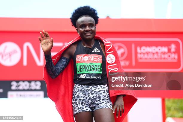 Joyciline Jepkosgei of Kenya celebrates winning the Women's Elite Race during the 2021 Virgin Money London Marathon at Tower Bridge on October 03,...