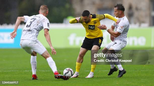 Niklas Hoffmann of Wuerzburg and Mirnes Pepic of Wuerzburg challenge Berkan Taz of Dortmund during the 3. Liga match between Borussia Dortmund II and...