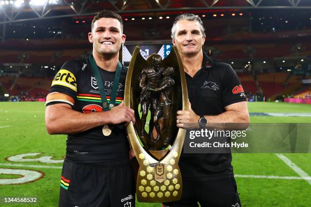 Nathan Cleary of the Panthers and Panthers coach Ivan Cleary pose with the NRL Premiership Trophy after victory in the 2021 NRL Grand Final match...