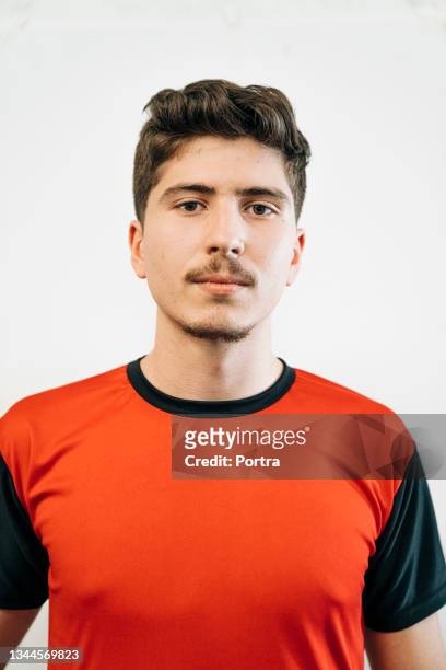 confident male soccer player at sports court - red sports jersey stock pictures, royalty-free photos & images