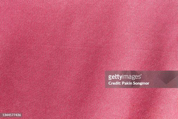 pink color sports clothing fabric football shirt jersey texture and textile background. - pink jersey stock-fotos und bilder