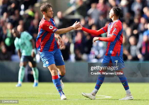 Michael Olise of Crystal Palace celebrates with teammate Joachim Andersen after scoring their side's first goal during the Premier League match...