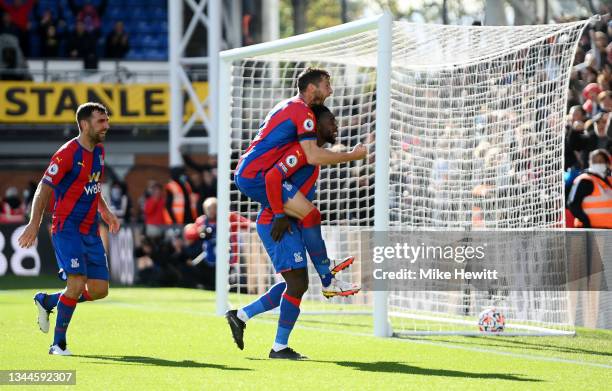 Jeffrey Schlupp of Crystal Palace celebrates with teammate Joel Ward after scoring their side's second goal during the Premier League match between...