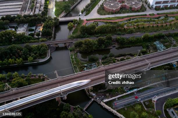 aerial view of a high-speed train passing by - landschaft asien schiene stock-fotos und bilder