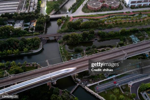 aerial view of a high-speed train passing by - images of china railway high speed trains stock pictures, royalty-free photos & images