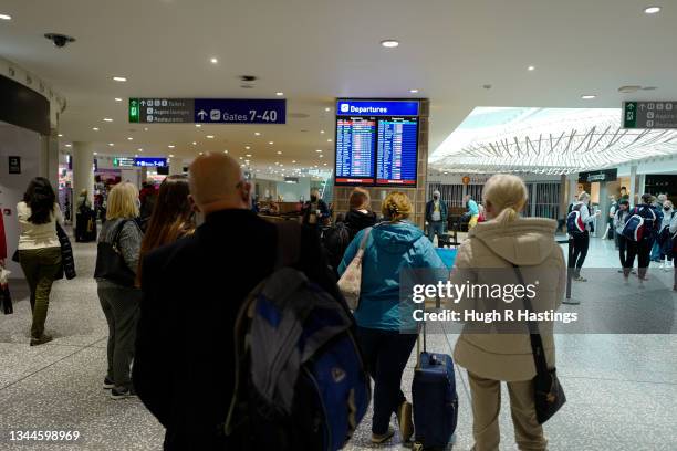 Passengers in the departures lounge at Bristol Airport on October 03, 2021 in Bristol, England. Starting tomorrow, the United Kingdom will simplify...