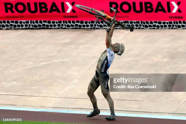 General view of Sonny Colbrelli of Italy and Team Bahrain Victorious lifts his bicycle to celebrates winning in the Roubaix Velodrome - Vélodrome...