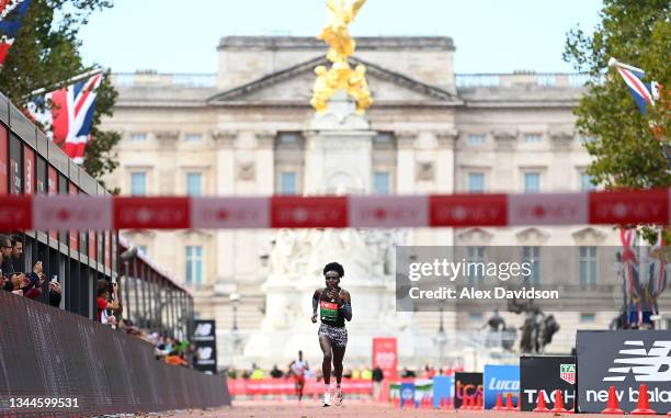 Joyciline Jepkosgei of Kenya heads down the mall on the way to winning the Women's Elite Race during the 2021 Virgin Money London Marathon at Tower...