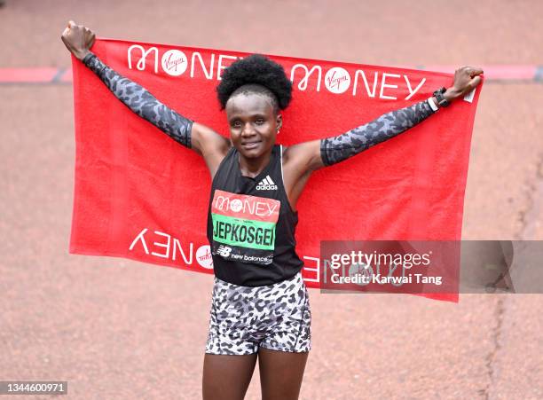 Joyciline Jepkosgei celebrates after winning the women’s elite London Marathon 2021 in The Mall on October 03, 2021 in London, England.