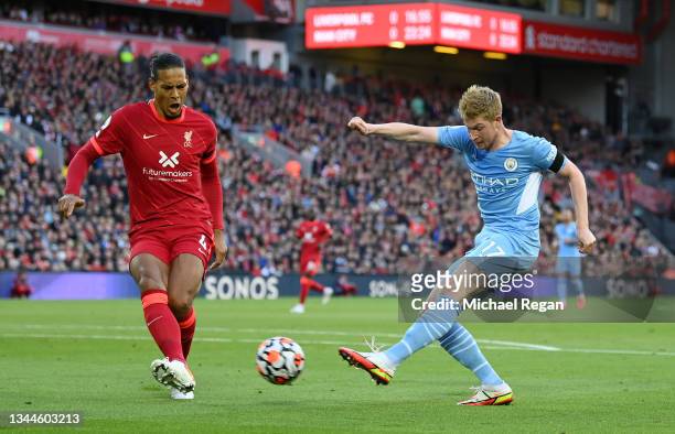 Kevin De Bruyne of Manchester City shoots whilst under pressure from Virgil van Dijk of Liverpool during the Premier League match between Liverpool...
