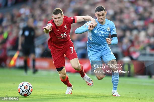 Phil Foden of Manchester City breaks away from James Milner of Liverpool during the Premier League match between Liverpool and Manchester City at...