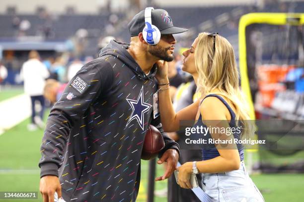Dak Prescott of the Dallas Cowboys kisses Natalie Buffett on the field before the game against the Carolina Panthers at AT&T Stadium on October 03,...