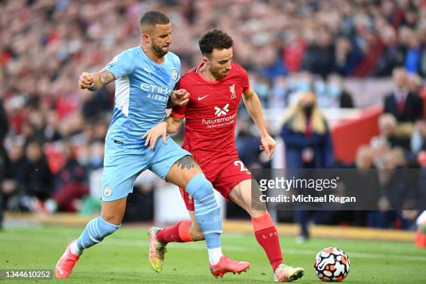 Diogo Jota of Liverpool is challenged by Kyle Walker of Manchester City during the Premier League match between Liverpool and Manchester City at...