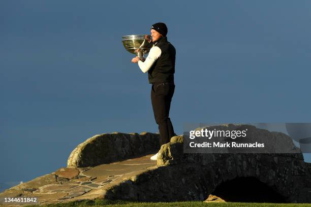 Danny Willett of England poses with the trophy on the Swilcan Bridge on the 18th hole following victory during Day Four of The Alfred Dunhill Links...