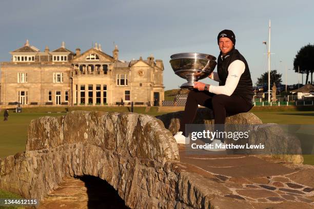 Danny Willett of England poses with the trophy on the Swilcan Bridge on the 18th hole following victory during Day Four of The Alfred Dunhill Links...